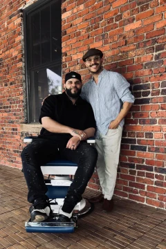 Two people beside a barber chair