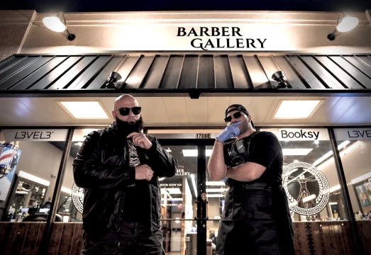 Two barbers outside Barber Gallery.