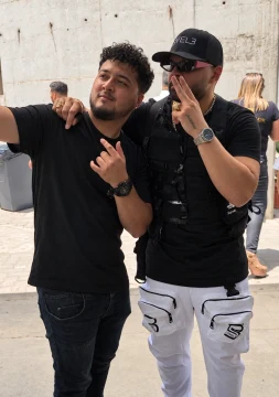 Two men posing for an outdoor selfie.