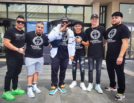 Tulpi with students and a colleague, several wearing Barber Gallery shirts, outside a hotel in Orlando.