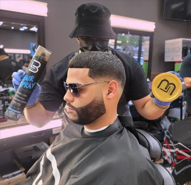 Tulpi presents L3VEL3 products behind a model with a finished haircut and beard at Barber Gallery.