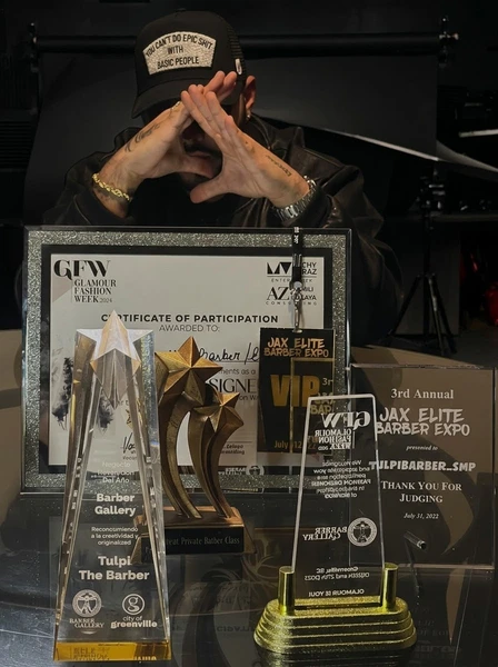 Carlos Gabriel Turpeau Ramos with plaques, certificates and recognitions